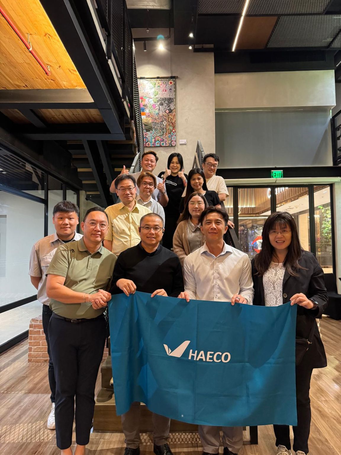 Event team holding a HAECO flag, from the December 2025 Manila results post.