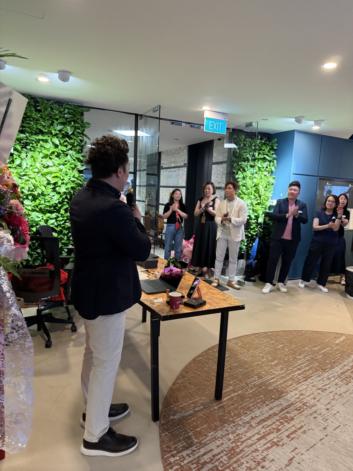 Guests applaud during OAI's new-office celebration.